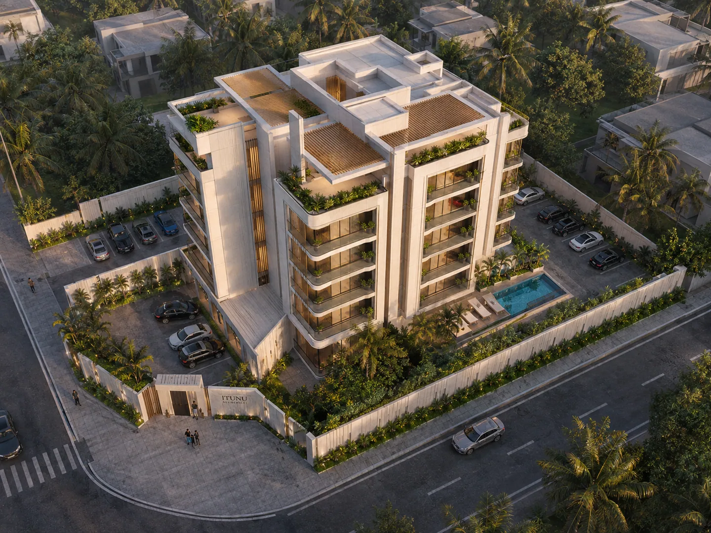 Aerial 3/4 view at sunset, warm sky, full site visible including pool and landscaping.