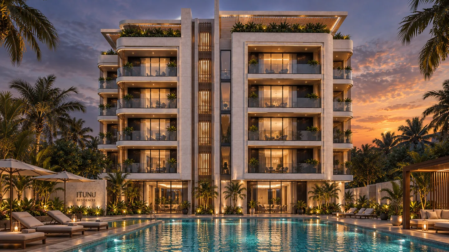 Landscape view of the building facade with the pool in the foreground at blue hour, 'ITUNU'-branded umbrella visible, loungers along the pool edge.